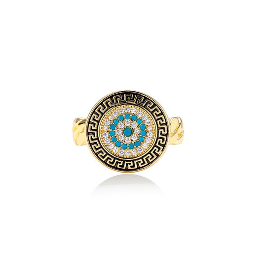 Gold chain ring with Greek key border and turquoise evil eye center on white background