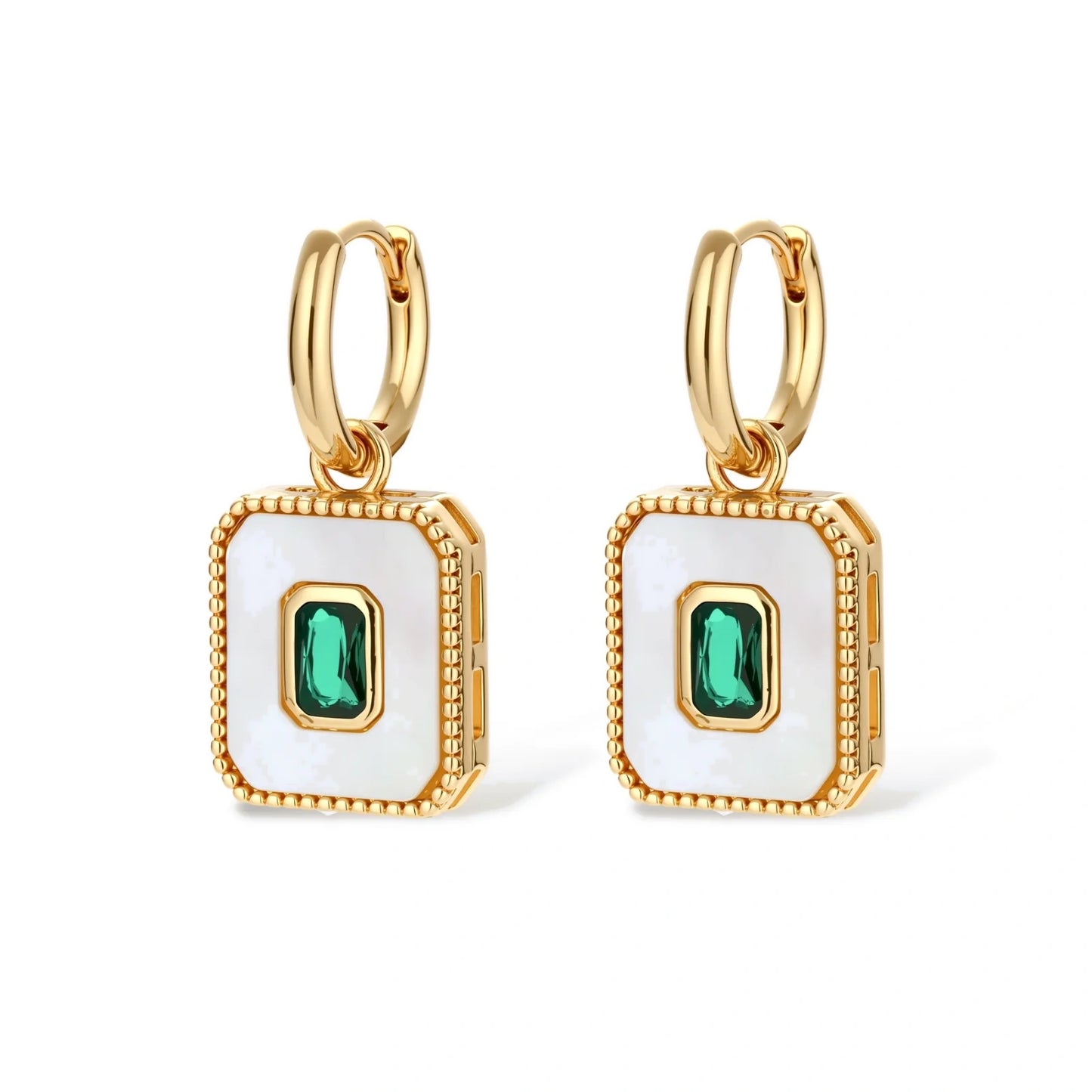 Gold-plated jewelry set with white enamel square pendants and emerald CZ stones on cream background.