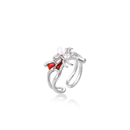 White gold plated spider ring with pearl body, clear zirconia center, and red enamel leg accents on adjustable band