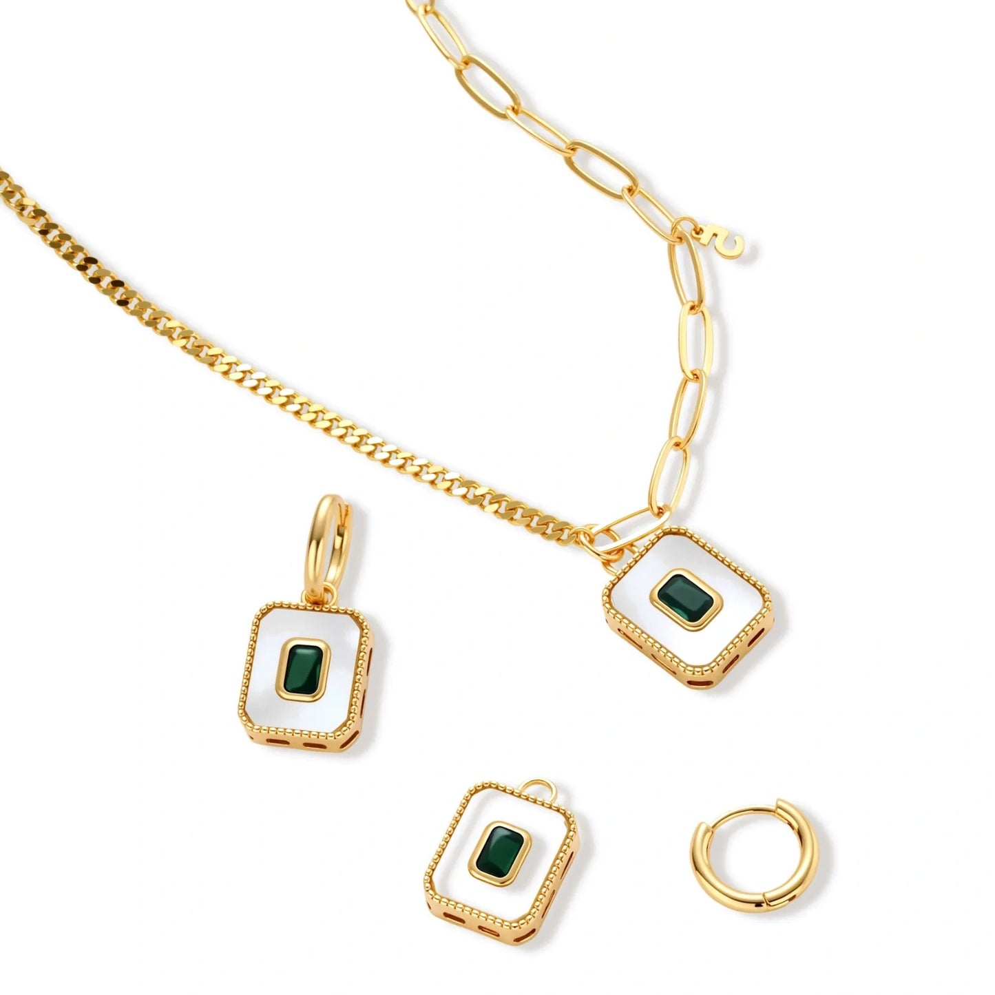 Gold-plated jewelry set with white enamel square pendants and emerald CZ stones on cream background.