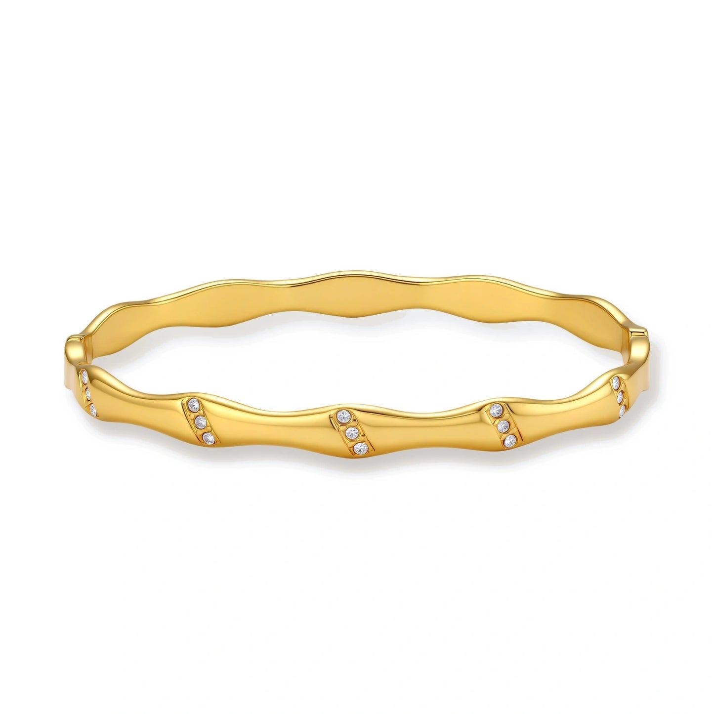 Gold-toned wavy bangle with bamboo-style segments and CZ crystal clusters on cream background. 18K plated stainless steel.