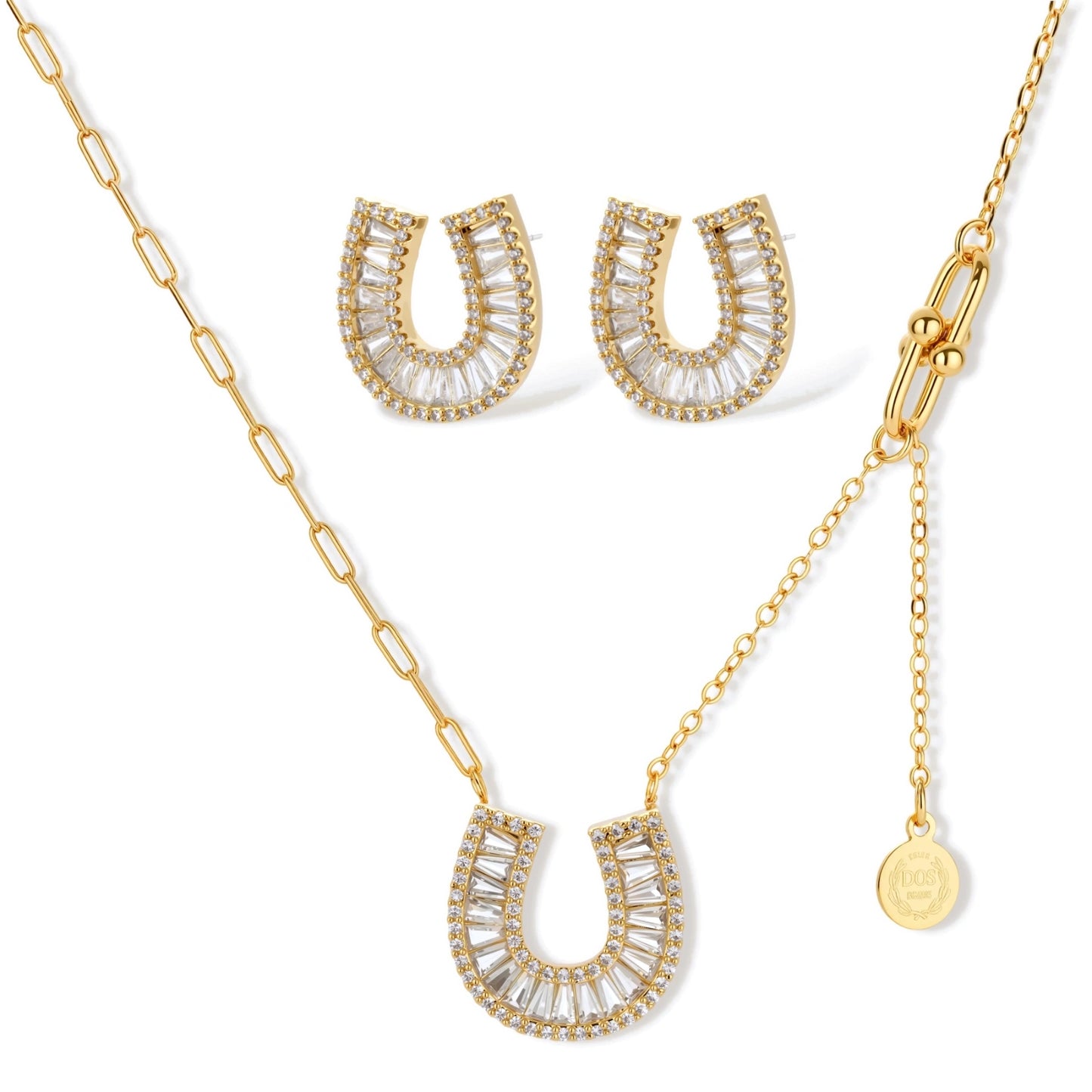 Gold-plated horseshoe necklace and earring set with baguette and round crystals arranged in geometric pattern on white background.