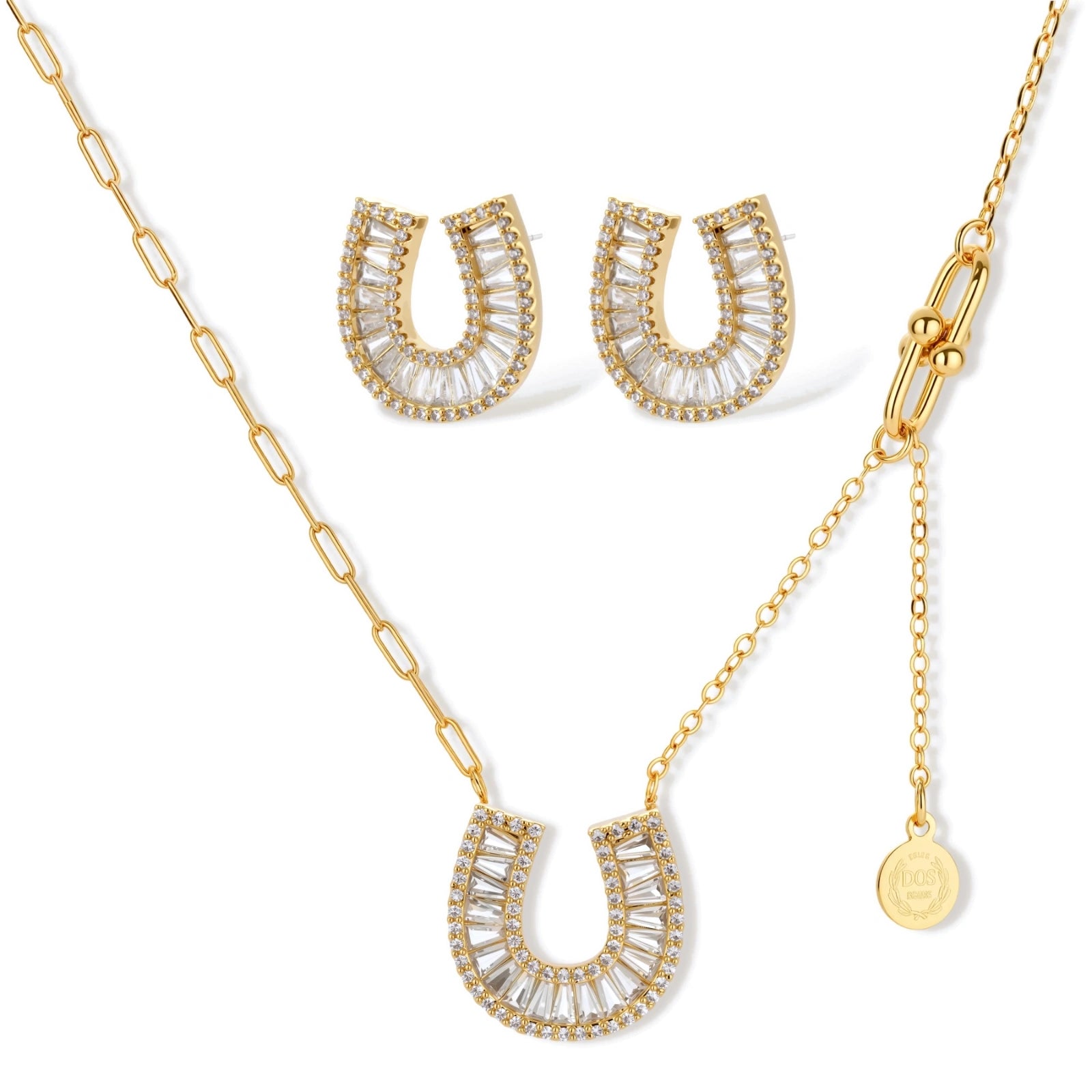 Gold-plated horseshoe necklace and earring set with baguette and round crystals arranged in geometric pattern on white background.